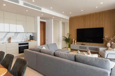 a living room with two couches and a television at Shanti Tranquil Escapes in Paralimni
