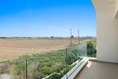 a view of a field from the balcony of a house at Serenity Waves Villa 26 in Larnaka