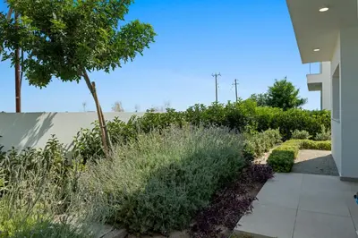 a garden with plants and a sidewalk at Serenity Waves Villa 26 in Larnaka