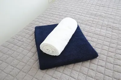 a roll of toilet paper sitting on a bed at Serenity Waves Villa 27 in Sophtadhes