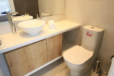 a bathroom with a toilet and a sink at Serenity Waves Villa 27 in Sophtadhes
