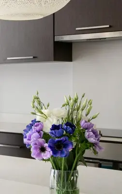 a vase filled with purple and white flowers on a table at Dazzling Protaras Villa Villa Akame 3 Bedrooms Beachfront in Protaras