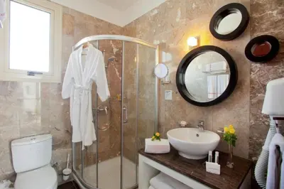 a bathroom with a shower and a toilet and a sink at Dazzling Protaras Villa Villa Akame 3 Bedrooms Beachfront in Protaras