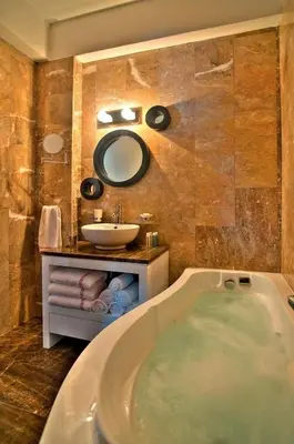 a bathroom with a tub and a sink at Exquisite Protaras Villa Villa Bulat 4 Bedrooms Beachfront in Protaras