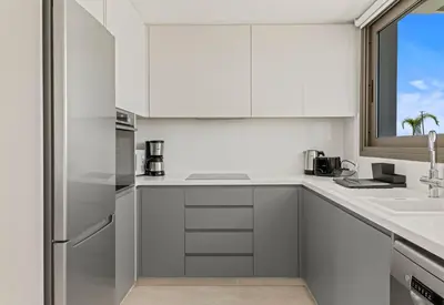 a white kitchen with a sink and a window at Serenity Waves Villa 22 in Larnaka