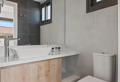 a bathroom with a sink and a toilet at Serenity Waves Villa 22 in Larnaka