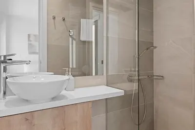 a bathroom with a sink and a glass shower at Serenity Waves Villa 9 in Sophtadhes