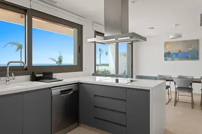 a kitchen with a sink and a large window at Serenity Waves Villa 7 in Sophtadhes