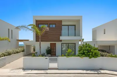 a house with a palm tree in front of it at Serenity Waves Villa 7 in Sophtadhes