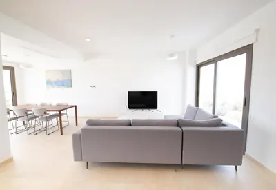 a white living room with a couch and a table at Serenity Waves Villa 7 in Sophtadhes