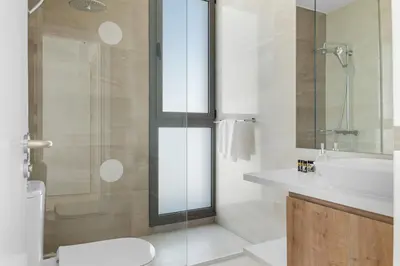a bathroom with a shower and a sink and a toilet at Serenity Waves Villa 4 in Sophtadhes