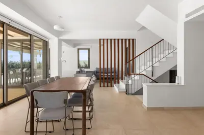 a dining room with a table and chairs at Serenity Waves Villa 4 in Sophtadhes