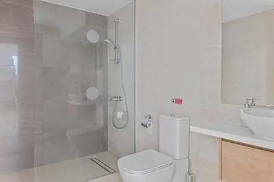 a bathroom with a shower and a toilet and a sink at Serenity Waves Villa 3 in Sophtadhes