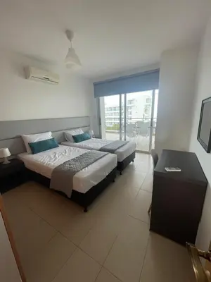 a hotel room with two beds and a balcony at Fig Tree View Apartments in Protaras
