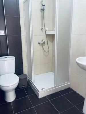 a bathroom with a shower with a toilet and a sink at Fig Tree View Apartments in Protaras