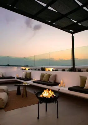 a living room with a fire pit in the middle at Amazing Protaras Villa Villa Lubbock 3 Bedrooms Private Outdoor Pool in Protaras