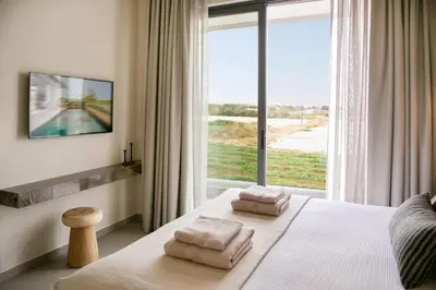 a bedroom with a bed with two towels on it at Amazing Protaras Villa Villa Lubbock 3 Bedrooms Private Outdoor Pool in Protaras