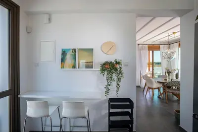a white dining room with a table and chairs at Extraordinary Protaras Villa Villa Leone 3 Bedrooms Private Outdoor Pool in Protaras