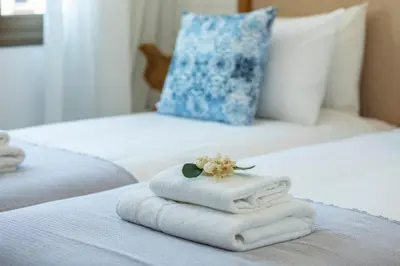 a pile of towels sitting on top of a bed at Extraordinary Protaras Villa Villa Leone 3 Bedrooms Private Outdoor Pool in Protaras