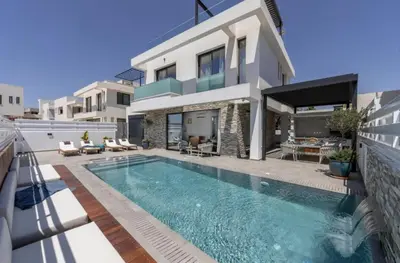 a villa with a swimming pool in front of a house at Magnificent Protaras Villa Villa Chelsea 3 Bedrooms Private Outdoor Pool in Protaras