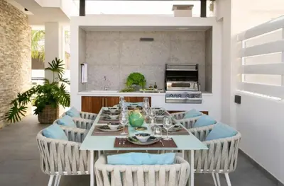 a dining room with a table with blue chairs at Magnificent Protaras Villa Villa Chelsea 3 Bedrooms Private Outdoor Pool in Protaras