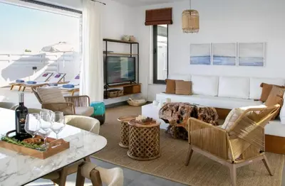 a living room with a couch and a table at Magnificent Protaras Villa Villa Chelsea 3 Bedrooms Private Outdoor Pool in Protaras