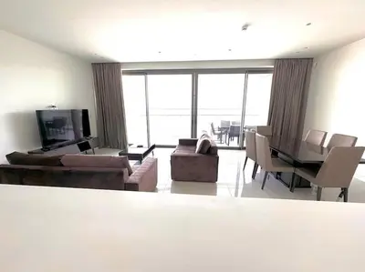 a living room with a couch and chairs and a television at Del Mar Beachfront 3 Bedroom 'A' Residence in Limassol