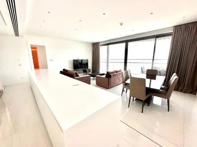 a white living room with a table and chairs at Del Mar Beachfront 3 Bedroom 'A' Residence in Limassol