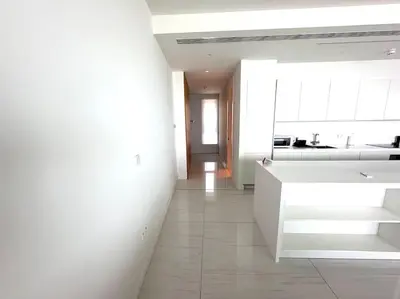 a white kitchen with a white counter and a sink at Del Mar Beachfront 3 Bedroom 'A' Residence in Limassol
