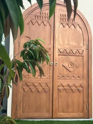 a wooden door in a building with a plant at Exotic Sea Boutique Adults Only in Protaras