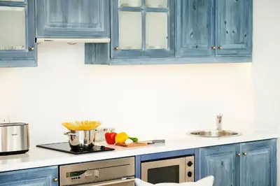 a kitchen with blue cabinets and a sink at Luxury Protaras Villa Villa Najenda 3 Bedrooms Private Outdoor Pool in Protaras