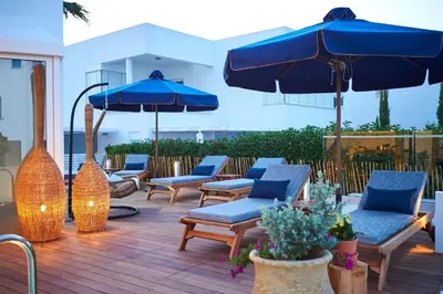 a group of chairs and umbrellas on a deck at Luxury Protaras Villa Villa Najenda 3 Bedrooms Private Outdoor Pool in Protaras