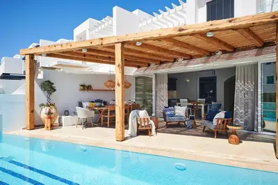 a villa with a swimming pool and a wooden pergola at Luxury Protaras Villa Villa Najenda 3 Bedrooms Private Outdoor Pool in Protaras