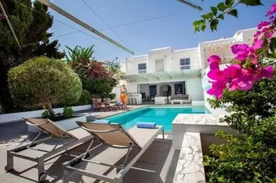 a swimming pool with two chairs and a house at Premium Protaras Villa Villa Mine 2 Bedrooms Private Outdoor Pool in Protaras