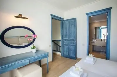 a bathroom with two beds and a mirror at Premium Protaras Villa Villa Mine 2 Bedrooms Private Outdoor Pool in Protaras