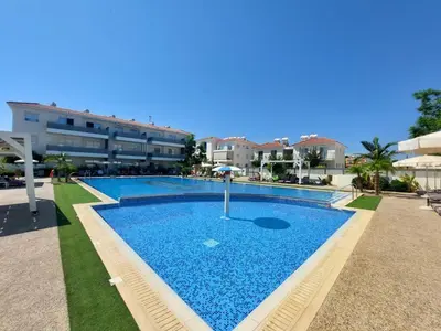 a large swimming pool in front of a building at Mythical Sands - Escape in Paralimni