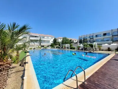 a large swimming pool with people in the water at Mythical Sands - Escape in Paralimni