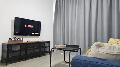 a living room with a tv and a blue couch at STAY Arpa Suite in Protaras