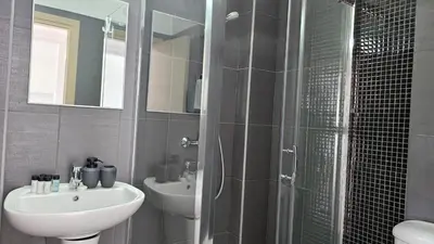 a bathroom with a sink and a toilet and a shower at STAY Arpa Suite in Protaras