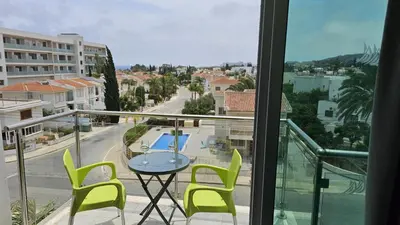 a balcony with a table and chairs and a view of a street at STAY Arpa Suite in Protaras