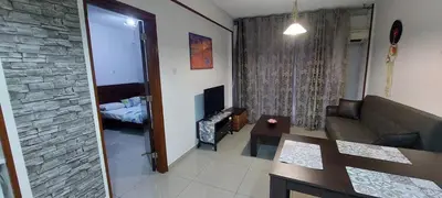 a living room with a couch and a bedroom at Paradise by the Sea in Larnaka