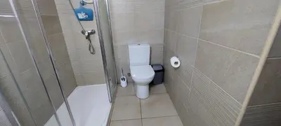 a bathroom with a shower and a toilet and a tub at Paradise by the Sea in Larnaka