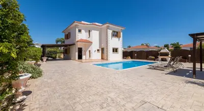 a house with a swimming pool in a yard at Elena Gardens Villa in Ayia Napa