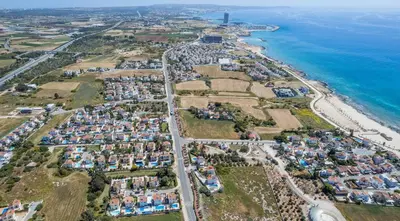 an aerial view of a village next to the ocean at Elena Gardens Villa in Ayia Napa