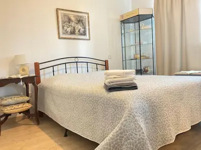 a bedroom with a bed with towels on it at Central cozy apt in quiet area in Engomi in Nicosia