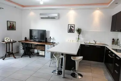 a kitchen with a table and a desk in it at Central cozy apt in quiet area in Engomi in Nicosia