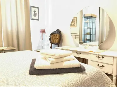 a bedroom with a bed with a vanity and a mirror at Central cozy apt in quiet area in Engomi in Nicosia