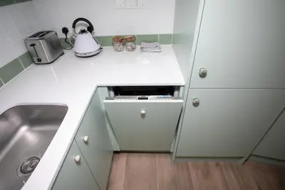 a small kitchen with a sink and a counter at Palmove Luxurious Beachfront Apt in Larnaka