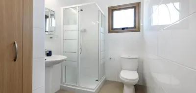 a white bathroom with a toilet and a sink at Potamos Villa - Villa Kymma 4 in Ayia Napa
