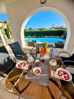 a table with food and wine on a patio at Potamos Villa - Villa Kymma 4 in Ayia Napa